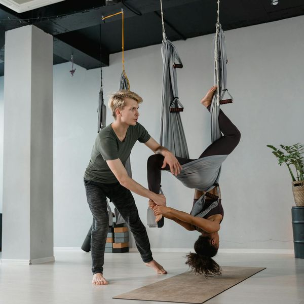 Professional female yoga instructor smiling warmly at the camera.